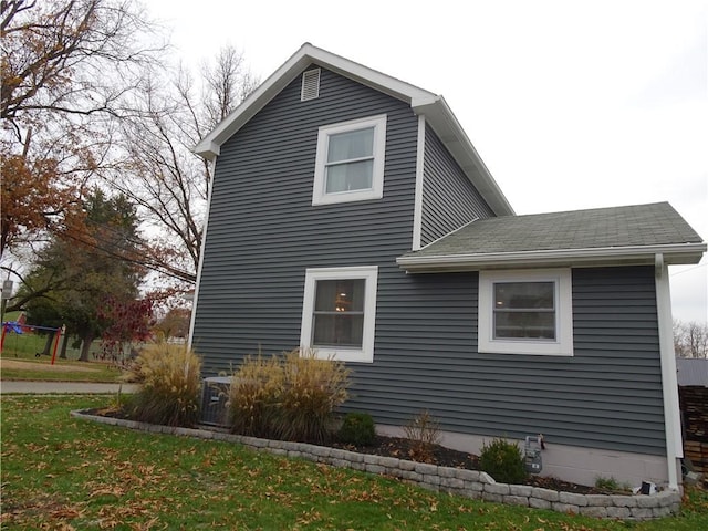 view of home's exterior featuring a yard and central air condition unit