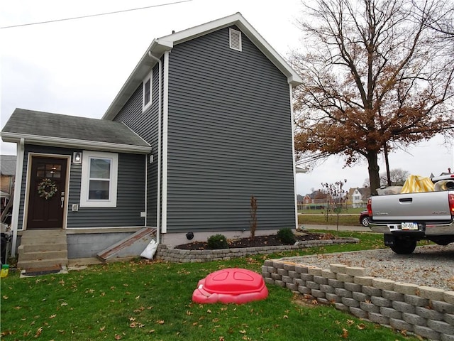 view of side of home with a lawn