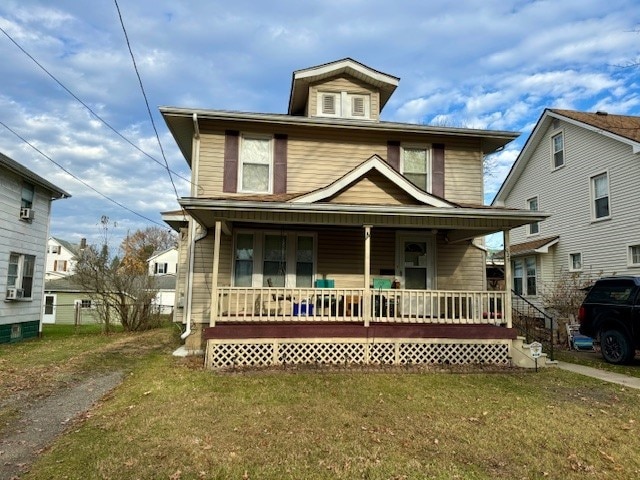 front of property featuring covered porch and a front lawn