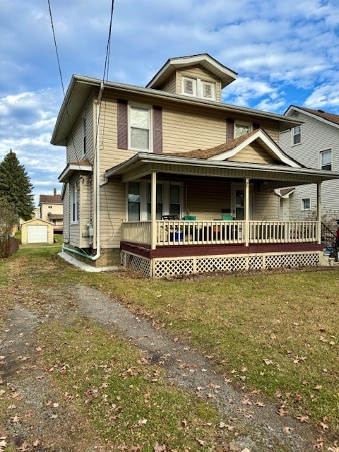 view of front of property with a porch, a garage, and an outdoor structure