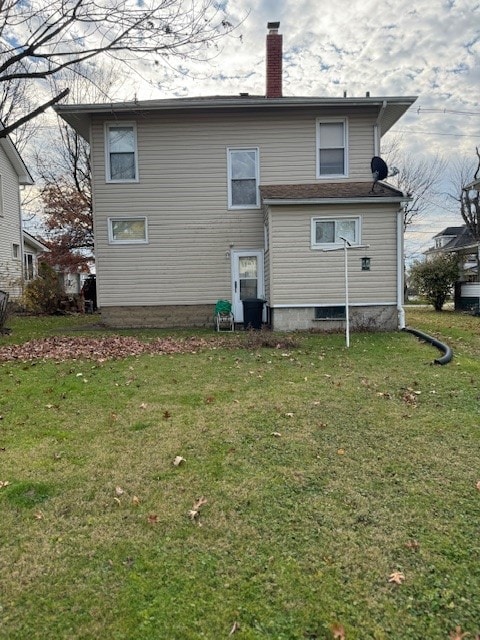 rear view of house with a yard