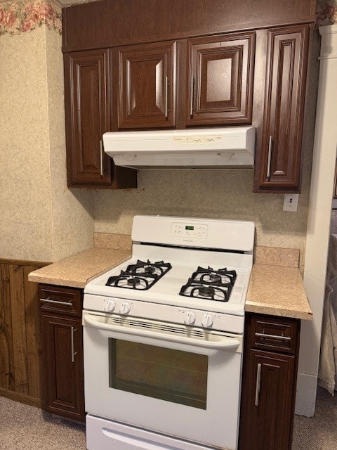 kitchen featuring dark brown cabinets and white range with gas stovetop