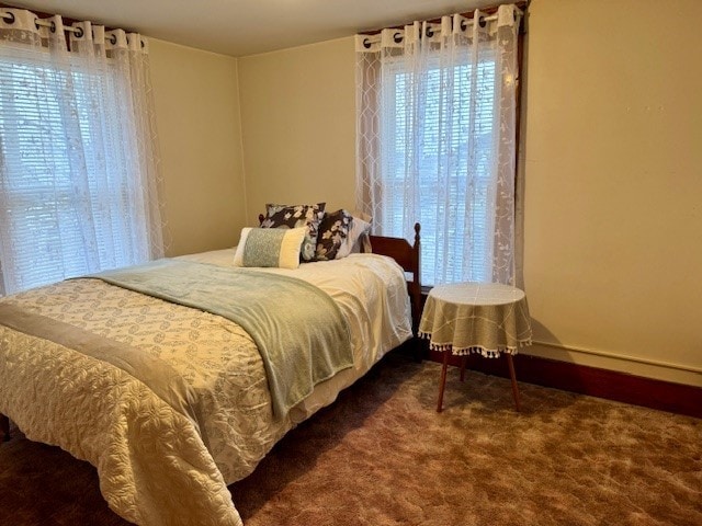 bedroom featuring dark colored carpet