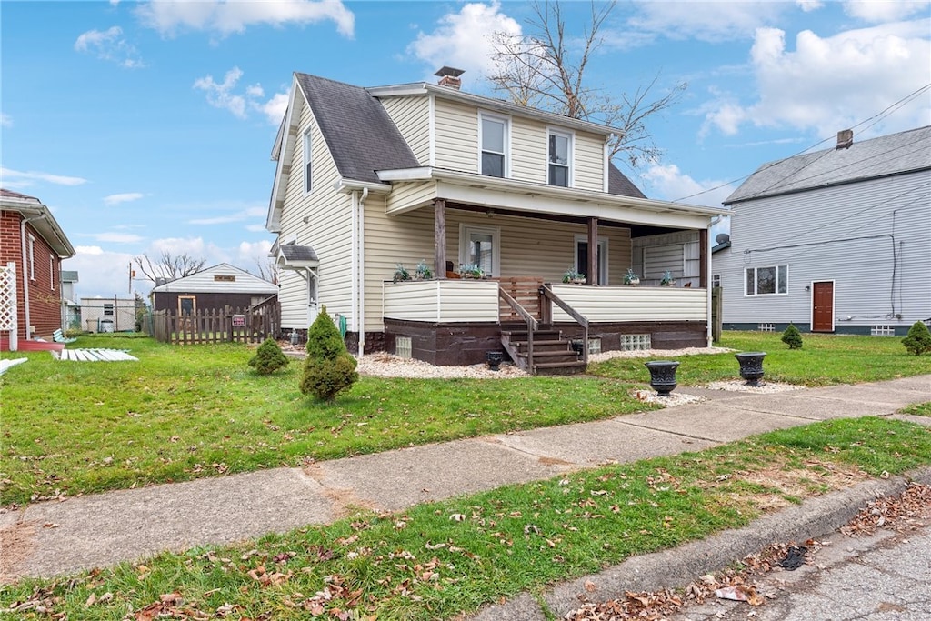 bungalow-style home featuring covered porch and a front yard