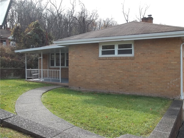 view of property exterior featuring a yard and covered porch