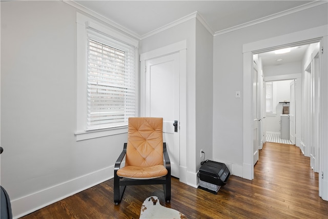 sitting room with dark hardwood / wood-style floors and crown molding