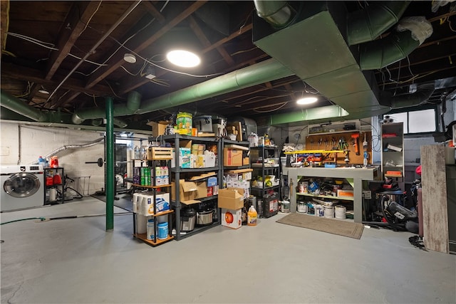 basement with washer / clothes dryer and a workshop area