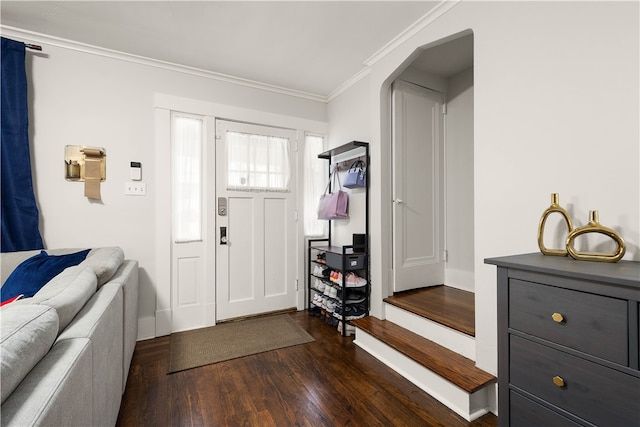 foyer entrance featuring crown molding and dark wood-type flooring