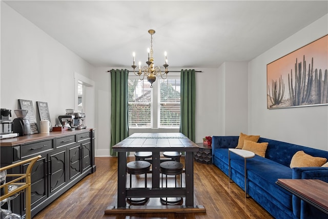 dining area featuring dark hardwood / wood-style floors and an inviting chandelier