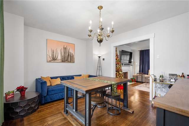 dining room with an inviting chandelier and dark wood-type flooring