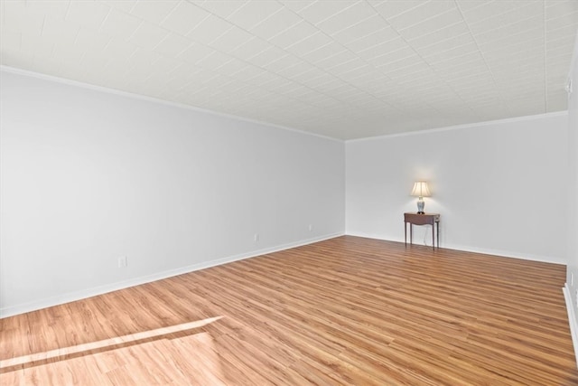 spare room featuring hardwood / wood-style floors and ornamental molding