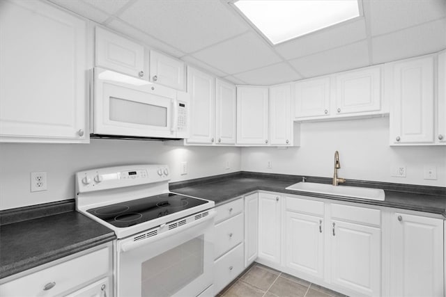 kitchen with sink, white cabinets, a drop ceiling, and white appliances