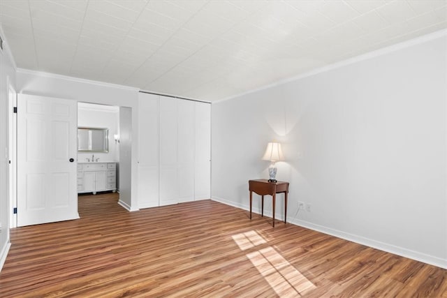 spare room featuring ornamental molding and hardwood / wood-style flooring