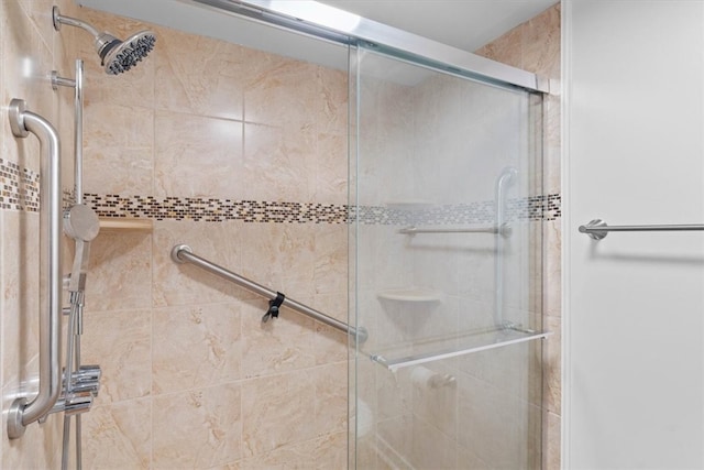 bathroom featuring a shower with shower door