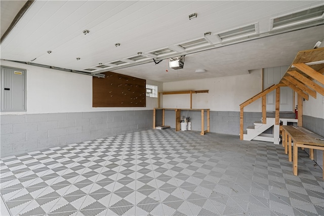 garage featuring electric panel and a garage door opener