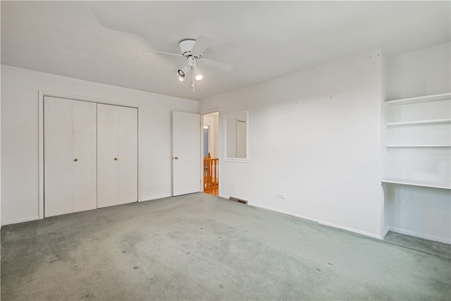 unfurnished bedroom with ceiling fan and carpet floors