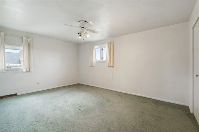 unfurnished room with carpet flooring, ceiling fan, and plenty of natural light