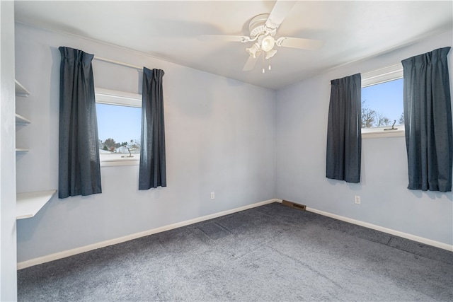 empty room featuring carpet flooring, ceiling fan, and plenty of natural light