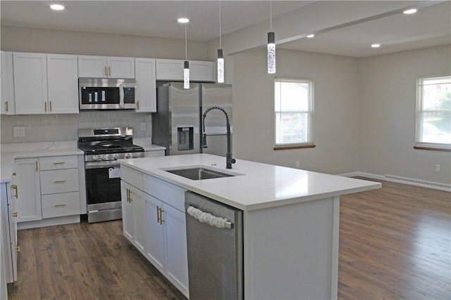 kitchen featuring plenty of natural light, sink, a kitchen island with sink, and appliances with stainless steel finishes