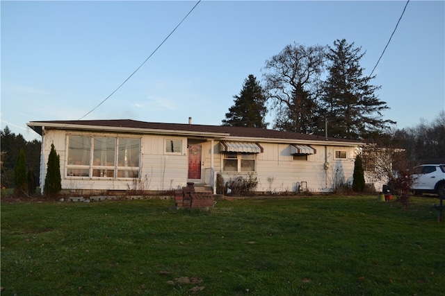 ranch-style home with a front lawn