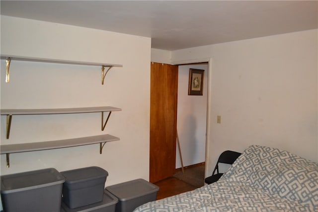 bedroom with dark wood-type flooring