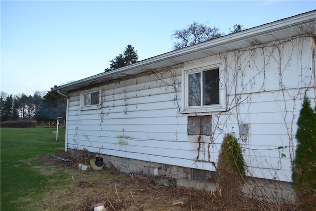 view of side of property with a yard