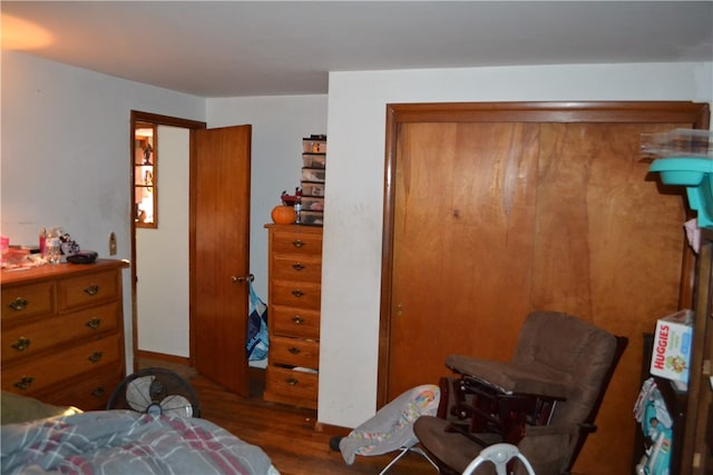 bedroom with dark wood-type flooring