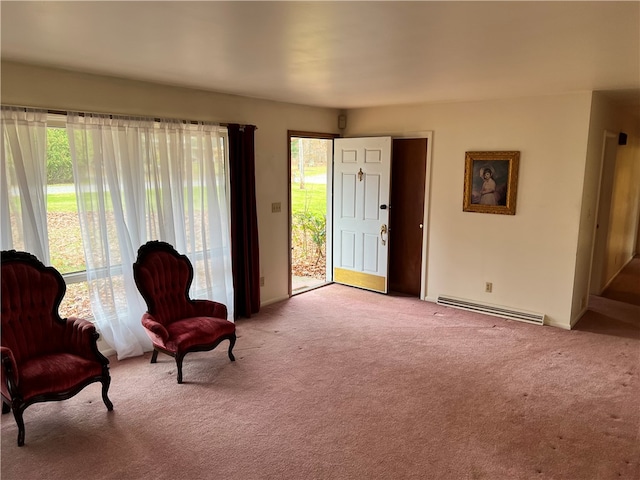 living area with light carpet and baseboard heating