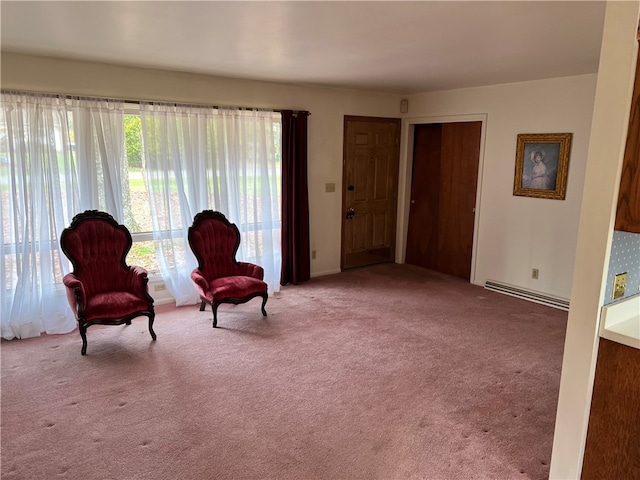 sitting room featuring light colored carpet and a baseboard heating unit