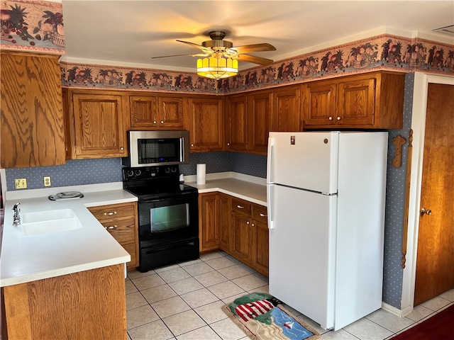 kitchen featuring ceiling fan, sink, white refrigerator, black / electric stove, and light tile patterned flooring