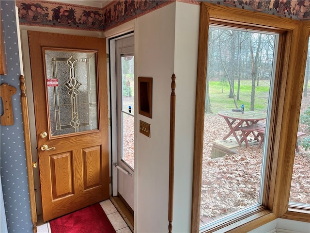 foyer entrance featuring light tile patterned floors and plenty of natural light