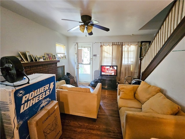 living room featuring ceiling fan and dark wood-type flooring