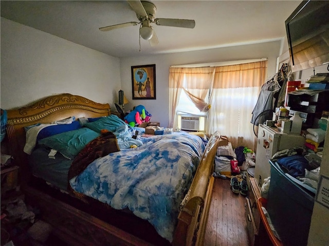 bedroom with ceiling fan and dark hardwood / wood-style flooring