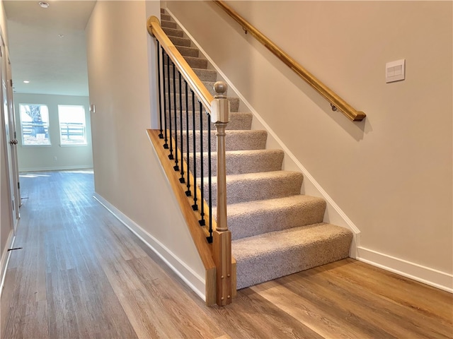 staircase with wood-type flooring