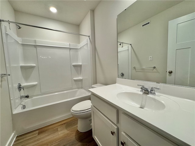 full bathroom featuring washtub / shower combination, toilet, vanity, and hardwood / wood-style flooring