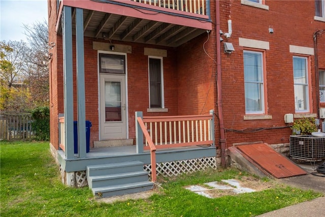 doorway to property with cooling unit and a balcony