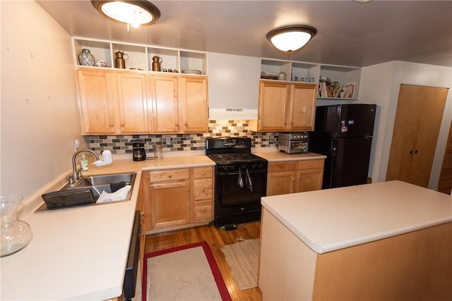 kitchen featuring decorative backsplash, sink, light brown cabinets, and black appliances