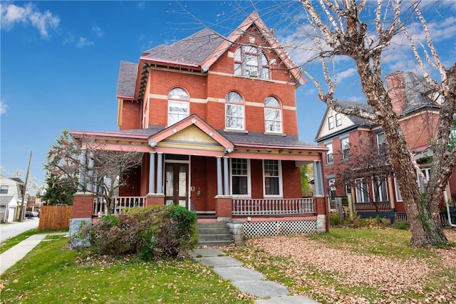 view of front of house featuring a front yard and covered porch