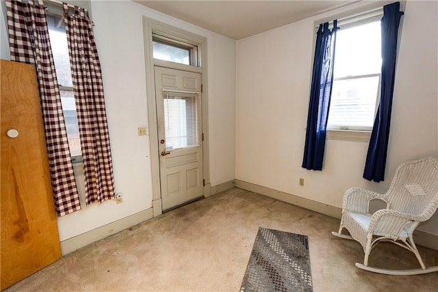 view of carpeted foyer entrance