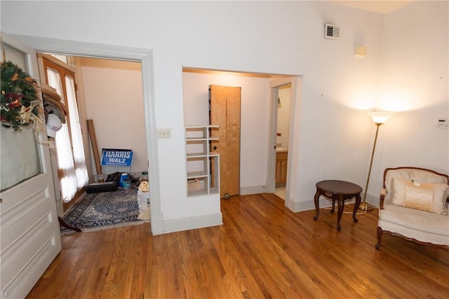 sitting room featuring wood-type flooring and french doors