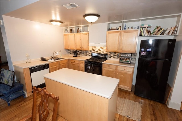 kitchen with light brown cabinetry, sink, wood-type flooring, and black appliances