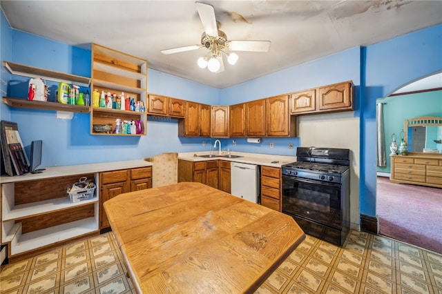 kitchen featuring white dishwasher, black range with gas stovetop, sink, ceiling fan, and light colored carpet