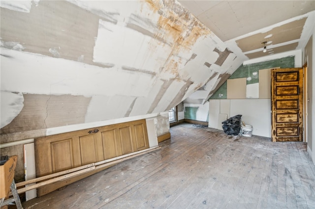 bonus room featuring dark hardwood / wood-style floors and lofted ceiling