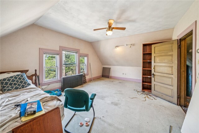 carpeted bedroom featuring radiator, vaulted ceiling, and ceiling fan