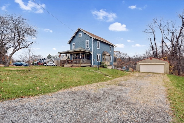 view of front of house featuring a front yard, a porch, a garage, and an outdoor structure