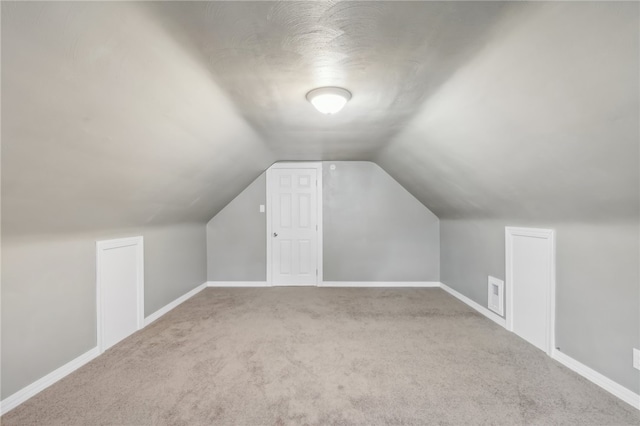 bonus room featuring carpet floors and lofted ceiling