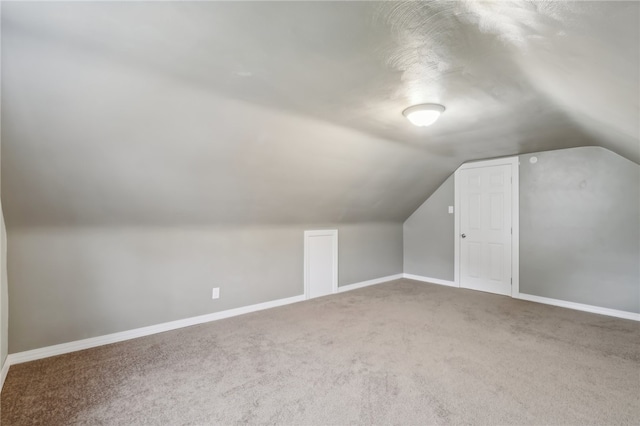 additional living space with carpet floors and lofted ceiling