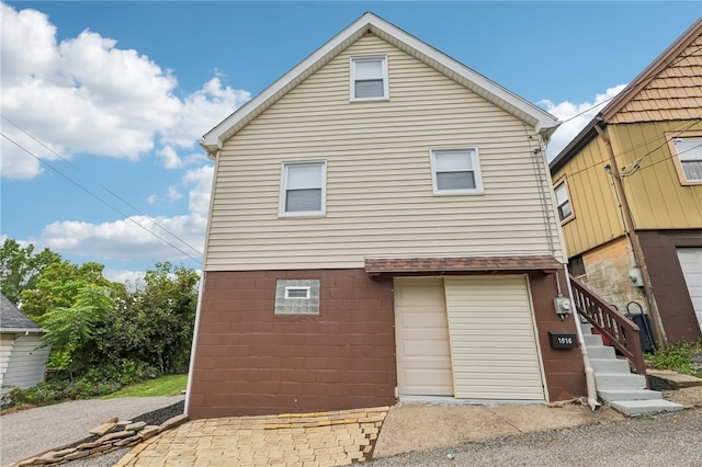 back of house featuring a garage