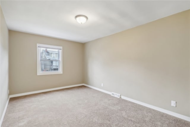 empty room with light colored carpet