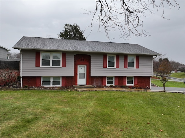 split foyer home with a front lawn